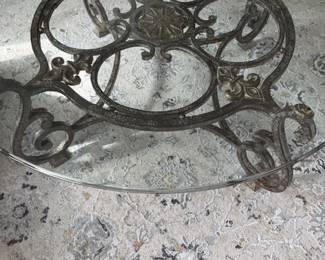 Large round glass and iron coffee table 