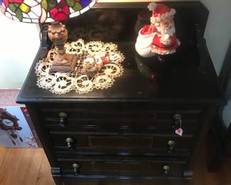 Unique 3 drawer chest with tassel like pulls! Bright stained glass lamp shines brightly over a couple of vintage Christmas pieces!