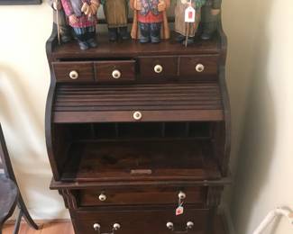 Cute roll top pine desk and displayed on top is a set of carved wood figurines!