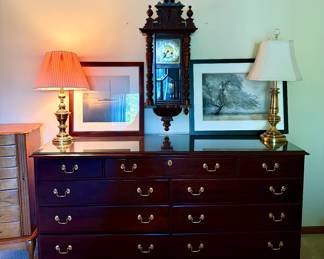 Dresser, brass lamps, wall art
