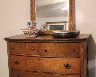 Vintage 4-drawer dresser; decorative wall mirror; decorative water pitcher and bowl set.