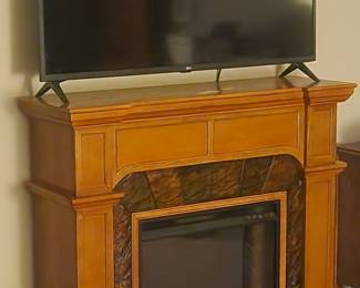 Large, Flat Screen Television and Electric Faux Fireplace