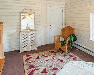 Rug, mirro and wicker chair and small side table