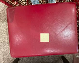 Red ottoman with black legs. 