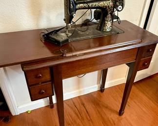 Antique Singer sewing machine in cabinet