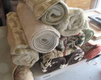 Numerous throw rugs, just taken from moving and storage box.