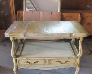 Serving cart with matching wall hanging mirror.