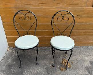pair of wrought iron bistro chairs
