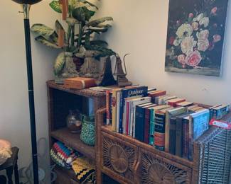 Wicker shelves, books, frames and other decor