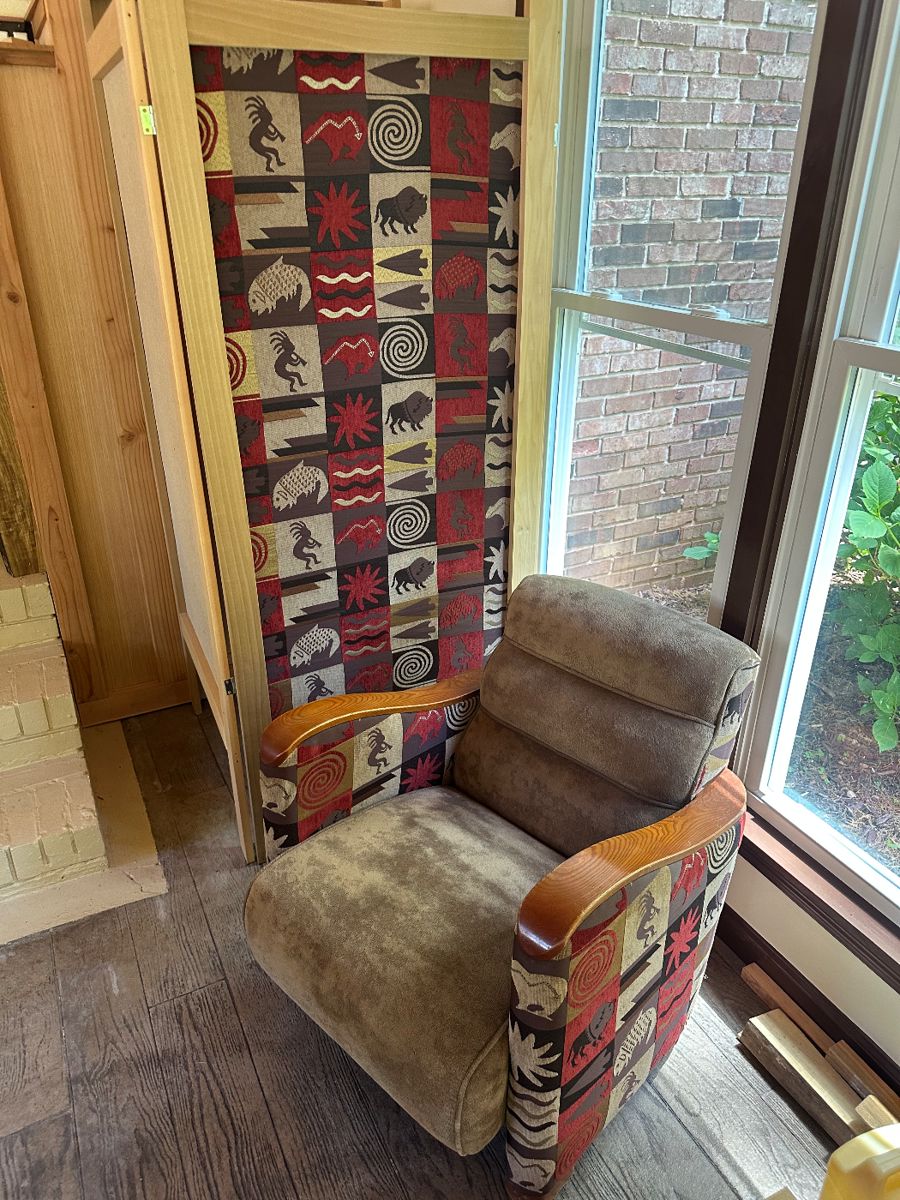 Privacy screen with wood frame and same native design material as used in club chairs.