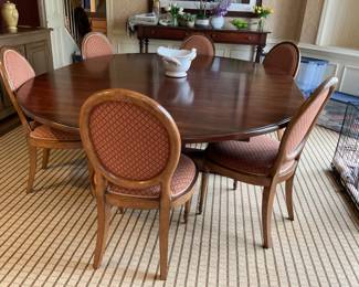 Custom Dining Table by Wright Table Company. 72” diameter table top split into oval with one 24” leaf. Base is 4 Balusters on raised legs . Split base . Distressed wood finish - Khaki on Cherry . Ogee edge on table top.