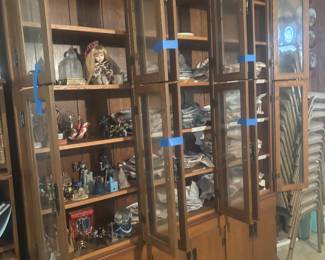 Beautiful wood cabinet. Lots of plates by different artists. Horses, dolls, animals, knights, etc