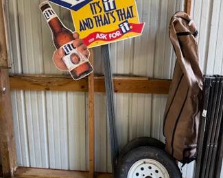Lots of signs some old some new, trailer tires and canopy frame