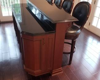 Freestanding two-tier bar is approximately 8 feet long; 4 bar stools. Floating hardwood floor