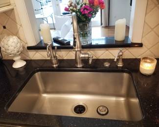 Kitchen includes sink, faucet and disposal along with countertops