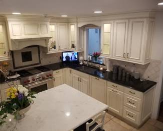 Elegant L-shaped kitchen with well appointed upper and lower cabinets