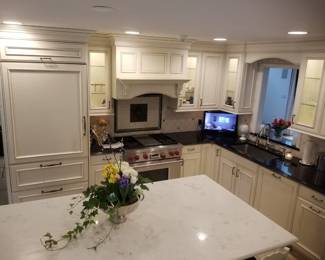 L-shaped kitchen includes range hood