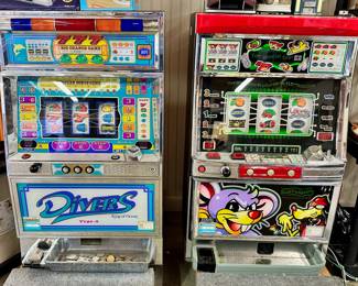 Pair of slot machines with a few tokens.