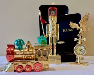 Miniature Bulova brass timepieces.