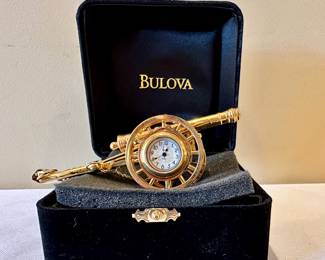 Miniature Bulova brass timepieces.