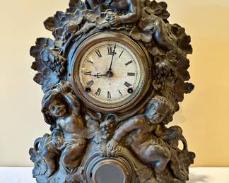 Metal front mantle clock manufactured by N Muller , New York, model number 49. Late 19th century.