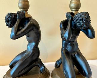 Pair black and gold male sculpture candlestick holders.
