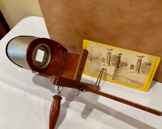 Stereoscope and hundreds of cards with storage case.