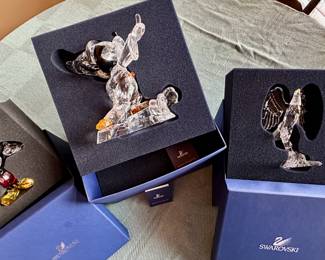 Swarovski Mickey Mouse and bald eagle figurines with boxes.