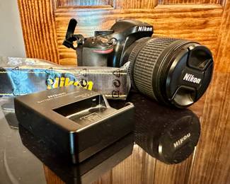 Nikon D5200 digital SLR camera with 18 - 105mm lens and battery charger (no cable).