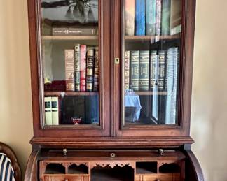 Antique roll-top desk. Decorative pediment sits on top (unattached and not original to desk).