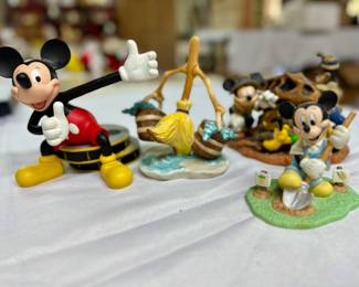 Various Disney Mickey Mouse figurines.