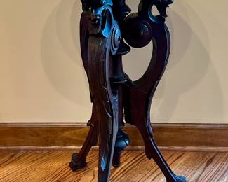 Marble-top dragons head table.