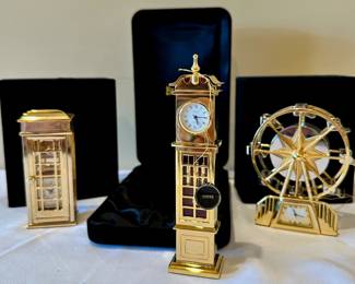 Miniature Bulova brass timepieces.