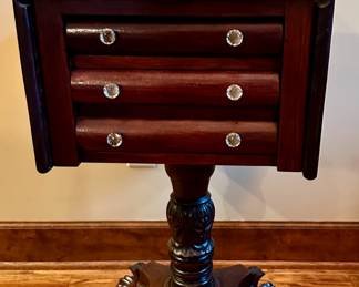 Mahogany drop leaf side table with three drawers.