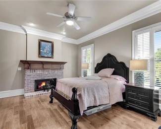 Queen black wood traditional bed, Haverty’s bedside chests (29.5”hx30”w), pair of aqua decorative lamps. Metalic Castle Artwork over fireplace.