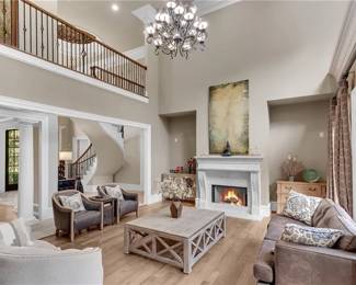 Living Room Leather Sofa, Pair of Leather Chairs Upholstered Sofa, Coffee Table (59”x47”), 2 chests flanking fireplace, Large artwork over fireplace, decorative accessories