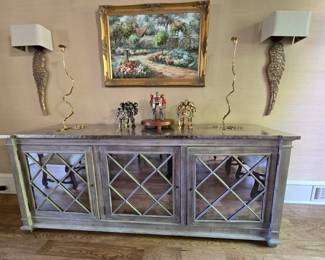 Mirrored console cabinet with steel top (7.5’ wide), Gold candle stick art pieces (There are 2 other similar pairs in sale.) Artwork.