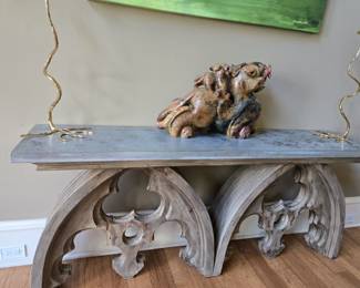 Console Table - 6 ft wide wooden arch base (split in left of center of left arch). Gold Candle Sticks and very heavy jade Foo Dragon Statue.