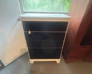 All wooden dresser painted white with black drawers