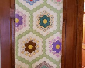 This 'grandmother's flower garden' quilt is hand stitched