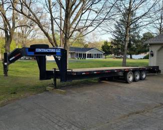 This 30 ft. gooseneck deckover trailer has three axles rated for 7,000 lbs each. The trailer has a flat wood floored section that is 8 ft wide and 25 ft long . Included are a tool /storage box and spare tire