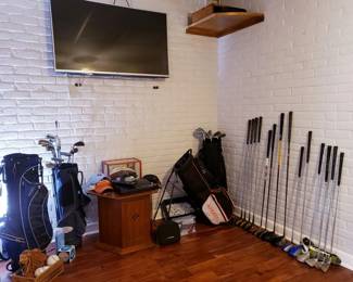 Assorted golf clubs and bags