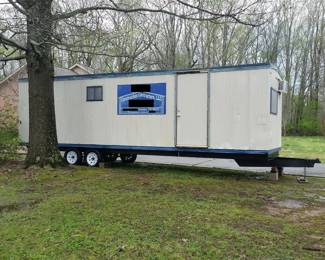 The construction office/storage trailer is a little over 8 ft wide and 28 ft long, (excluding the tongue). Hitch is for 2-5/16" ball. Shown without steps installed.