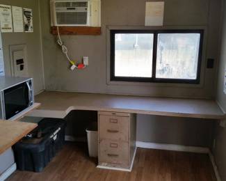 There is also a counter, file cabinet, and air conditioner.