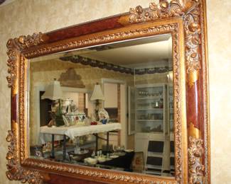 impressive gold-framed wall mirror