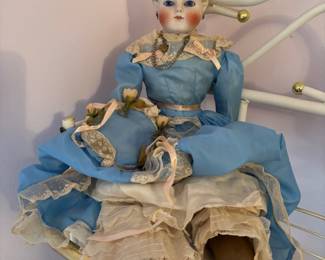 Looks like we have a German Simon & Halbig Parian bisque head doll with glass eyes. Missing one shoe (we are still looking)