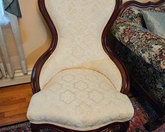 White Upholstered Chair With Wooden Flower Details