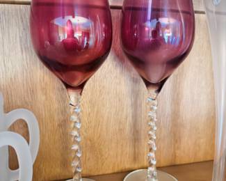 Handblown wine glasses with twisted stems, one is purple and other is mauve