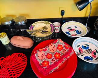 Glass kitchen canisters, Pier 1 red dinner plates, floral bowls