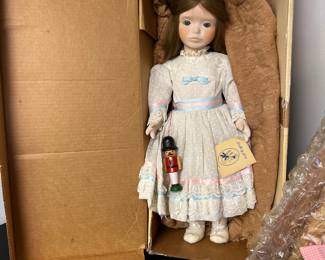 Porcelain Doll by Jerri from the 1990s. 23 inches tall, dressed from the Nutcracker "Clara", complete with a Nutcracker accessory. Original box and includes a hang tag.